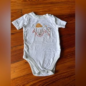 White onesie with snap closure at neck and bottom